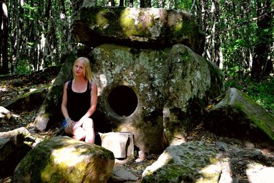 Rear view of woman standing in forest