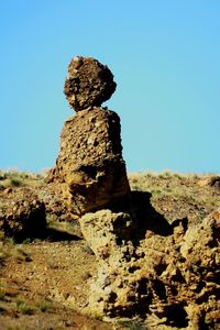 Stone rock against clear sky