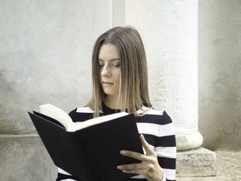 Portrait of young woman using laptop at home