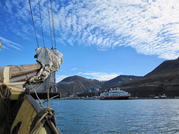 Sailboat by sea against sky