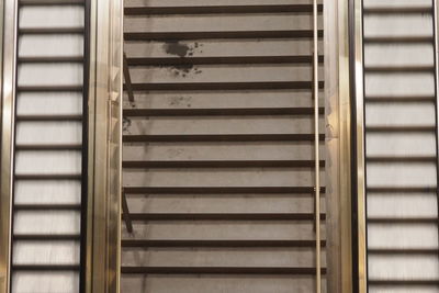 Full frame shot of stairway amidst escalators at railroad station