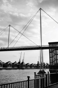 View of bridge over river against cloudy sky