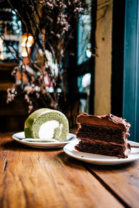 Close-up of cake slices in plates on table