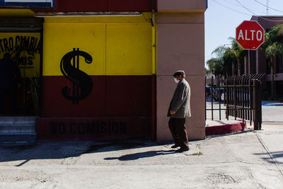 Full length side view of man sign on street