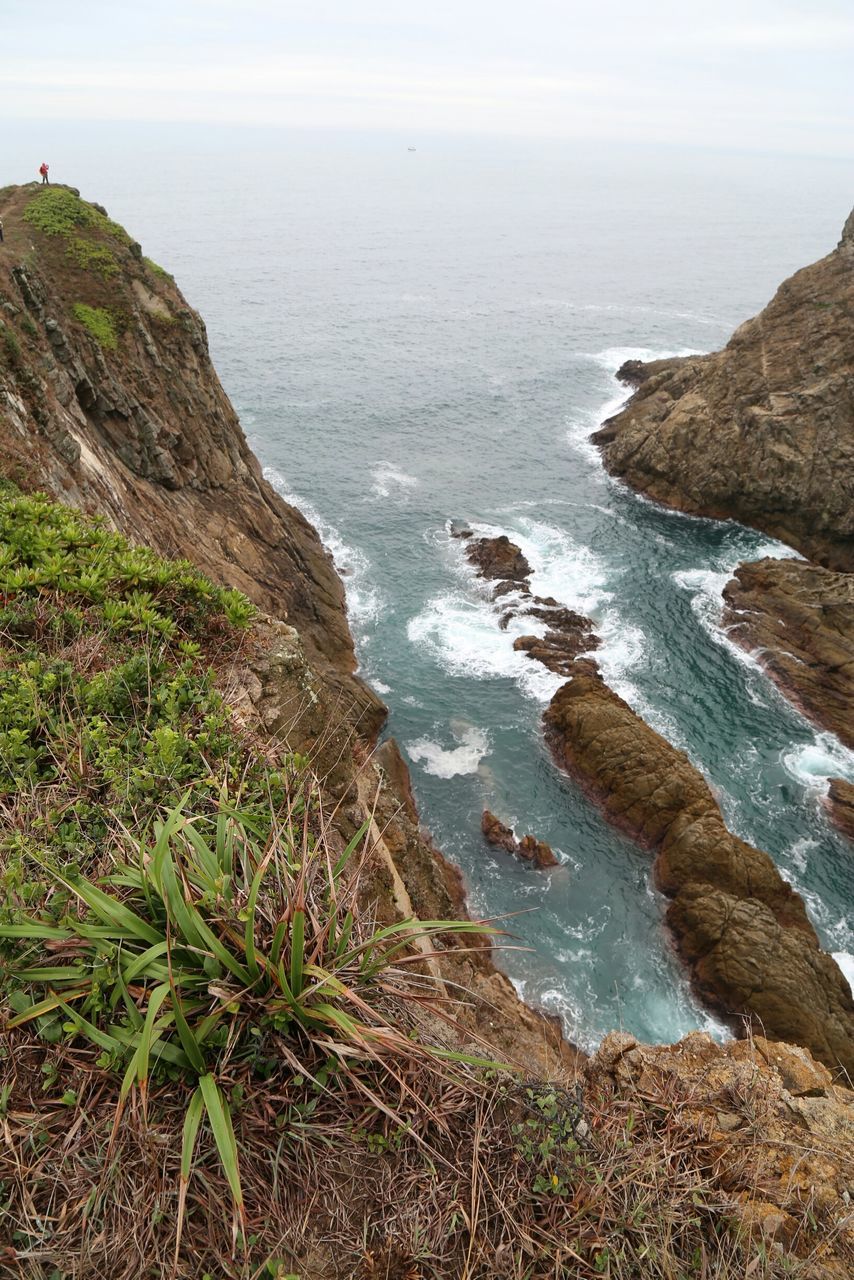 sea, water, horizon over water, tranquil scene, scenics, tranquility, beauty in nature, beach, rock formation, coastline, shore, nature, rock - object, cliff, sky, idyllic, rock, high angle view, mountain, remote