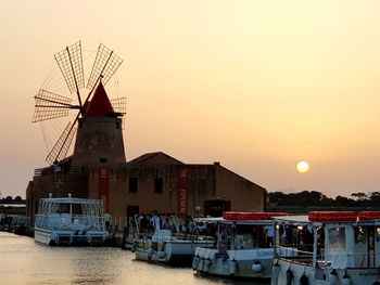 Ship in sea against clear sky during sunset