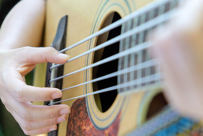 Cropped image of man playing guitar