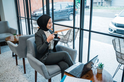 Young woman sitting on chair