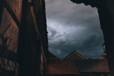 Low angle view of houses against cloudy sky