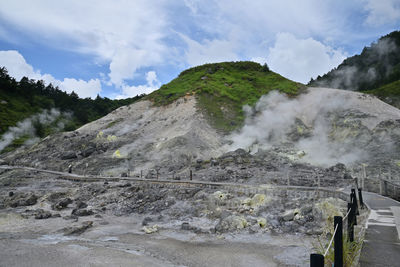 Panoramic shot of road by mountain against sky