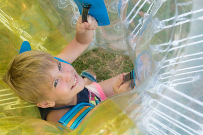 Portrait of happy boy holding inflatable ball