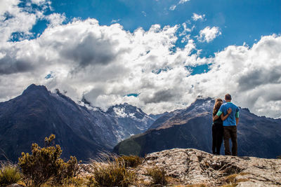 Man standing on mountain against sky