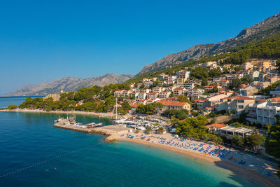 Aerial view of brela town below biokovo mountain, the adriatic sea, croatia