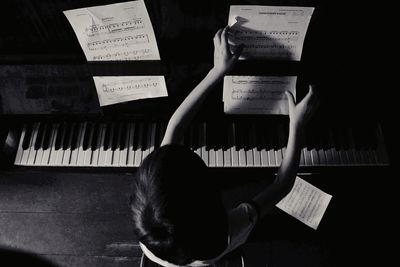High angle view of boy playing piano