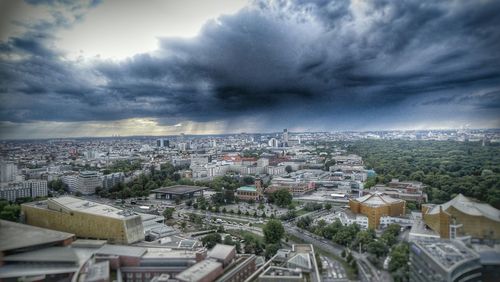 Cityscape against cloudy sky