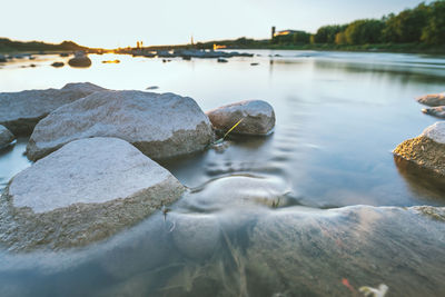 Close-up of rocks in calm lake