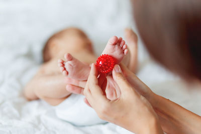 Midsection of woman holding strawberry