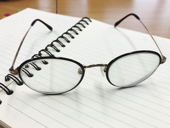 Close-up of eyeglasses on blank open book