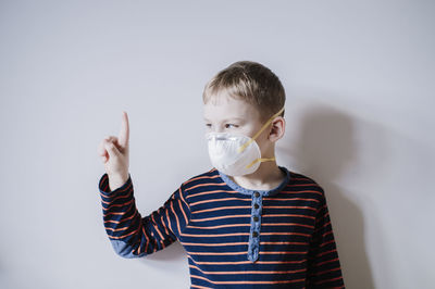 Portrait of boy standing against white background