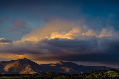 Scenic view of mountains against dramatic sky