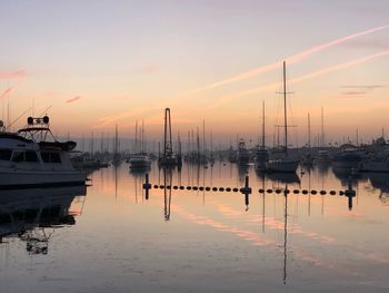 Boats in marina at sunset