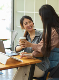 Businesswoman sharing coffee at office