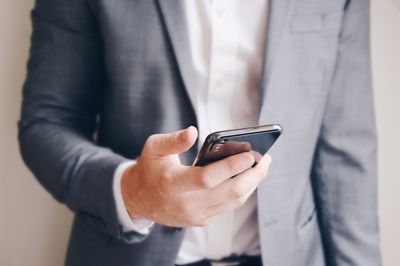Midsection of businessman using phone