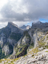 Mountainous landscape with gray clouds in summer day