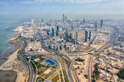 High angle view of modern buildings in city against sky