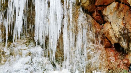 Close-up of snow on rock in cave