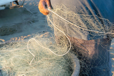 High angle view of fishing net on beach