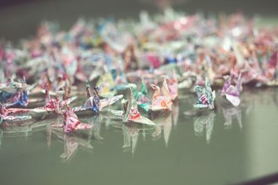 Close-up of origami birds on table
