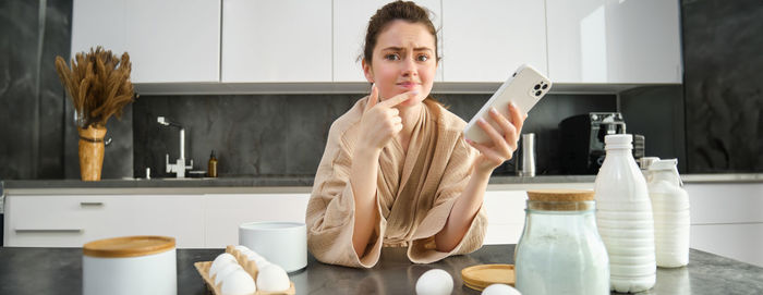 Portrait of young woman using mobile phone