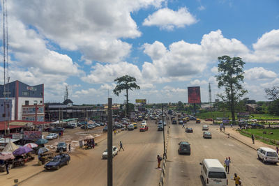 High angle view of vehicles on road against cloudy sky