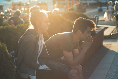 Young couple sitting in city