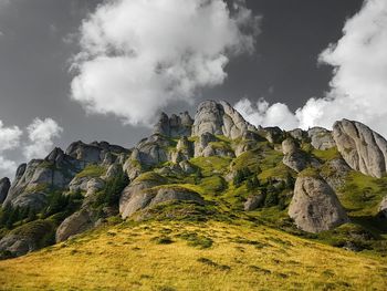 Low angle view of rocks against sky
