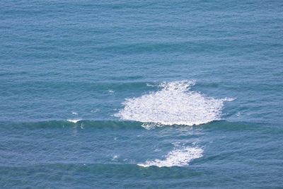 High angle full frame shot of waves breaking in turquoise colored sea