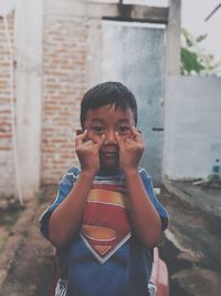 Portrait of smiling boy standing outdoors