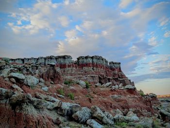 Rock formations on landscape against sky