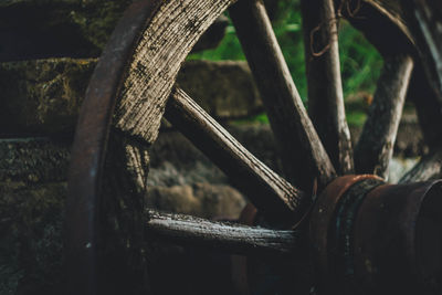 Close-up of old rusty wheel on field