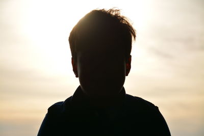 Close-up of silhouette boy against sky