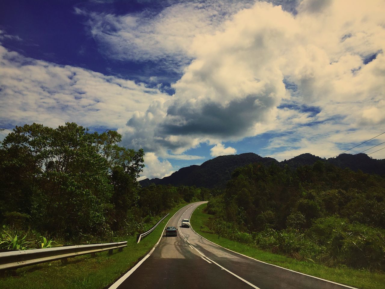 road, the way forward, transportation, cloud - sky, sky, mountain, tree, highway, scenics, landscape, day, nature, winding road, dividing line, no people, tranquil scene, outdoors, mountain range, tranquility, beauty in nature, curve, mountain road