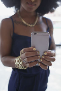 A young woman taking a self portrait.