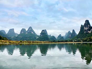 Scenic view of lake and mountains against sky