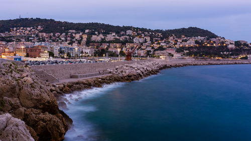 High angle view of townscape by sea against sky