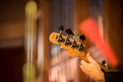 Cropped hand of man playing guitar