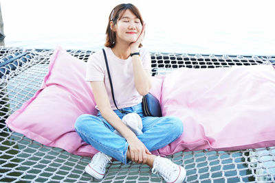 Portrait of a young woman sitting on carpet