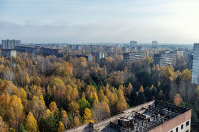 High angle view of trees and buildings against sky