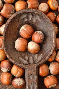 Directly above shot of hazelnuts in wooden spoon on table