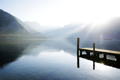 Scenic view of lake against mountains during sunset